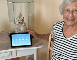 Smiling elderly woman with her Alexa virtual assistant