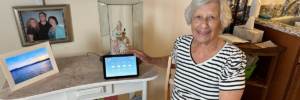 Smiling elderly woman with her Alexa virtual assistant